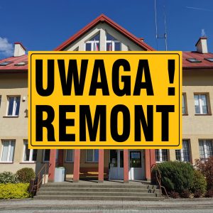 Frontowa ściana budynku urzędu gminy z dużą ilością okien, pośrodku czarny napis na żółtym tle "Uwaga! Remont"