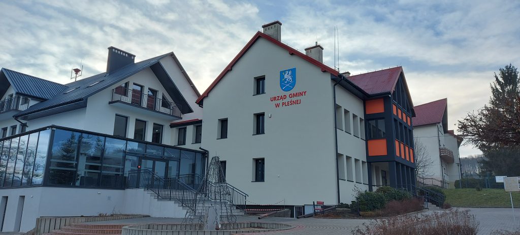 Budynek Urzędu Gminy w Pleśnej po termomodernizacji, widok na ścianę boczną, obok fragmentu budynku Centrum Kultury